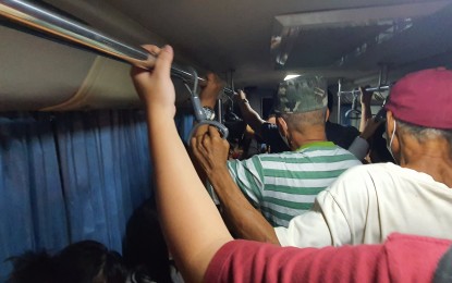 <p><strong>FULL CAPACITY</strong>. Some commuters stand in line inside a modern jeepney as they return to their homes during the rush hour in Cagayan de Oro City. Public utility jeepneys will have an increased PHP1 on base fares starting Oct. 3, 2022 as announced by the Land Transportation Franchising and Regulatory Board in the Northern Mindanao Region. <em>(PNA photo by Nef Luczon)</em></p>