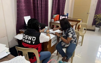 <p><strong>GRANT</strong>. One of the 57 individuals from Sorsogon province who are beneficiaries of a livelihood grant from the Department of Social Welfare and Development (DSWD) receives her aid on Wednesday (Sept. 21, 2022). Qualified for the social amelioration program are those who have an existing small business, or whose employment was affected by the pandemic, and did not benefit from other government interventions. <em>(Photo courtesy of DSWD Bicol)</em></p>