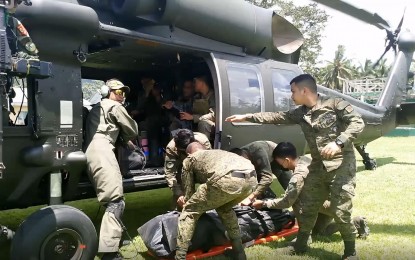 <p><strong>CASUALTY</strong>. Soldiers carry the body of a female rebel transported by a helicopter from the clash site in the mountains of Silvino Lobos, Northern Samar in this Sept. 20, 2022 photo. The female fighter died in a gun battle that happened in Senonogan de Tubang village, one of the communities that the rebels have been trying to recover in Silvino Lobos town. <em>(Photo courtesy of Philippine Army)</em></p>
