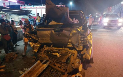 <p><strong>WRECKED</strong>. Bystanders look at the wrecked pick-up truck, one of the 14 vehicles which figured in a pileup on Friday (Sept. 23, 2022) in Tupi, South Cotabato. Two, including a child, died while 17 others were injured. <em>(Photo courtesy of Rolly Doanne Aquino)</em></p>