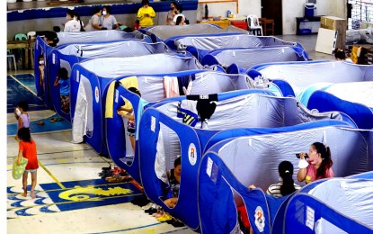 <p><strong>SAFE HAVEN.</strong> Families whose houses were affected by typhoon-induced flash floods are temporarily housed at the Delpan Sports Complex in Tondo, Manila on Monday (Sept. 26, 2022). The Manila government provided modular tents and food packs for at least 67 families as Typhoon Karding placed Metro Manila under Tropical Cyclone Wind Signal No. 4 on Sept. 25.<em> (PNA photo by Ben Briones)</em></p>