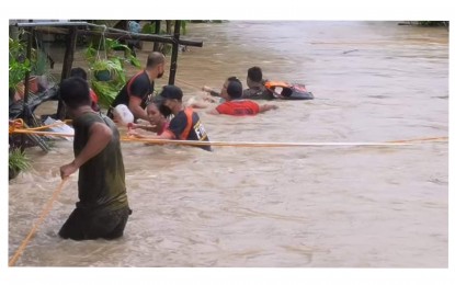 <p><strong>FLOOD RESCUE. </strong>Personnel of the Bureau of Fire Protection in Cauayan, Negros Occidental were among those who rescued residents from their flooded homes due to torrential rains brought by Typhoon Karding on Sunday (Sept. 25, 2022). At least 13 families have been evacuated while most of the cities and municipalities in the province have suspended classes due to inclement weather. <em>(Photo courtesy of BFP-Region 6 Cauayan Fire Station)</em> </p>