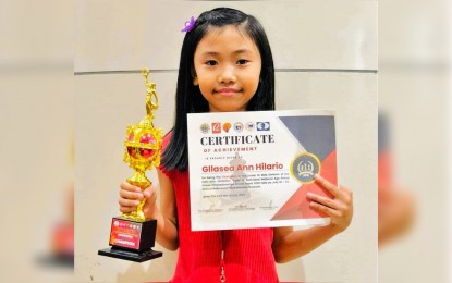 <p><strong>NATIONAL MASTER.</strong> Gllasea Ann Hilario shows her trophy and certificate after winning the Under-10 category of the National Age Group Chess Championships held in Malolos, Bulacan from July 19-24, 2022. She learned how to play chess at the age of four, after getting encouraged by her brother. <em>(Contributed photo)</em></p>