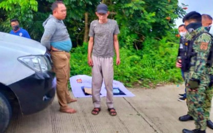 <p><strong>CORNERED.</strong> Police keep close watch on two drug suspects following their arrest during a sting operation in Marantao town, Lanao del Sur province, on Sept. 27, 2022. Seized from the duo were some PHP680,000 worth of shabu.<em> (Photo courtesy of Lanao del Sur PPO)</em></p>