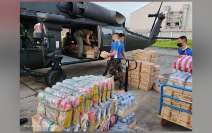 <p><strong>AID FOR TYPHOON VICTIMS.</strong> Relief goods for typhoon victims are loaded onto PAF's S-70i Black Hawk helicopter. The multi-functional combat utility helicopter can also be used for disaster response. <em>(Photo courtesy of PAF)</em></p>