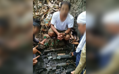 <p><strong>ARMS CACHE.</strong> Rodel Mandel (center), a former combatant of the dismantled New People’s Army Guerilla Front 18, reveals to government troopers the location of the rebels' hidden firearms in Barangay Magdug, Governor Generoso, Davao Oriental, on Sept. 27, 2022. At least five high-powered firearms were unearthed at the site. <em>(Photo courtesy of 10ID)</em></p>