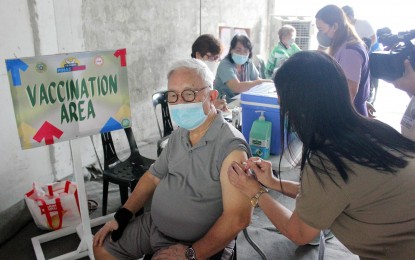 <p>An elderly man receives his Covid-19 vaccine in Cavite.<em> (PNA photo by Gil Calinga)</em></p>