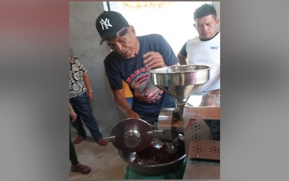 <p><strong>INTERVENTION.</strong> A member of the United Highlander Farmers Producers Cooperative in Senator Ninoy Aquino town, Sultan Kudarat province tries out a grinding equipment from the Department of Agrarian Reform in this undated photo. DAR said the improved processing facility is expected to boost the cooperative’s production and increase its profit. <em>(Courtesy of DAR)</em></p>