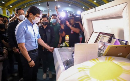 <p><strong>LAST RESPECTS</strong>. Interior Secretary Benhur Abalos pays his last respects to one of the five rescuers who died during the onslaught of Super Typhoon Karding during his visit to the Capitol Gym, Malolos, Bulacan on Friday night (Sept. 30, 2022). Abalos lauded the heroic deeds of the fallen rescuers. <em>(Photo courtesy of DILG)</em></p>