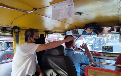 <p><strong>HIGHER FARES.</strong> A passenger pays his fare on a public utility jeepney plying the route Sta. Ana-Paco-LRT along Paco, Manila on Tuesday (Oct. 10, 2022). A group of public utility vehicle (PUV) drivers and operators are seeking the support of the public on its petition to add "surge pricing" during rush hours to jeepney and bus fares to help offset the continued rise in fuel prices. <em>(PNA photo by Alfred Frias)</em></p>