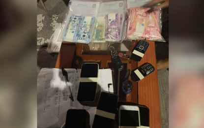 <p><strong>RECOVERED ITEMS.</strong> Cash and mobile phones are recovered from the possession of Davao City cops Chief Master Sgt. Renante Medina and Master Sgt. Christopher Ararao after their group robbed a businesswoman in Barangay San Jose, General Santos City on Oct. 3, 2022. While leaving the victim's house, local police flagged the vehicle of the suspects and recovered the PHP165,000 cash and other personal belongings the group stole. <em>(Photo courtesy of GenSan CPO)</em></p>