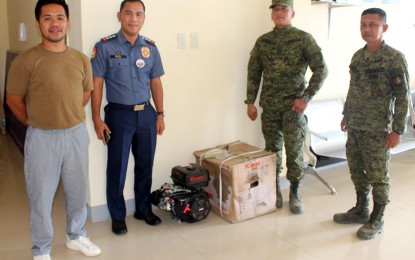 <p><strong>ENHANCING SEA PATROLS.</strong> Colonel Ariel Red (second from left), the acting Dinagat Islands provincial police chief, received Thursday (Oct. 6, 2022) the two units of boat engines provided by the provincial government. The boat engines were formally handed over by Niel Demerey (left), who represented Dinagat Islands Governor Nilo Demerey Jr. in the ceremony.<em> (Photo courtesy of Gov. Nilo Demerey Jr.)</em></p>