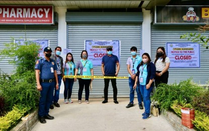<p><strong>PADLOCKED.</strong> Bureau of Internal Revenue (BIR) Revenue Region 18 (RR18) Director Rodrigo Rivamonte (center, in dark blue polo shirt) led BIR officials and personnel in the implementation of a closure order for 60 business establishments in the Soccsksargen Region on Friday (Oct. 7, 2022) for violation of internal revenue laws. Backed by the police, the BIR shut down an arcade in Tacurong City as one of the padlocked businesses.<em> (Photo courtesy of BIR-RR18)</em></p>