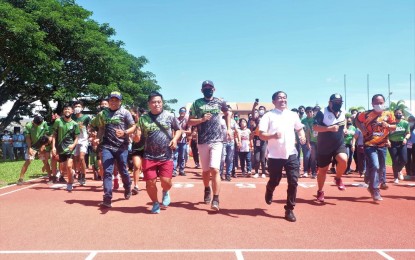 <p><strong>CEREMONIAL RUN.</strong> Davao del Norte Governor Edwin Jubahib (3rd from right) leads the ceremonial run marking the launch of the PHP34.8 million newly-rehabilitated Track Oval of the Davao del Norte Sports and Tourism Complex on Monday (Oct. 20, 2022). The sports facility was shut down before the pandemic due to a much-needed repair.<em> (Photo courtesy of DavNor PIO)</em></p>