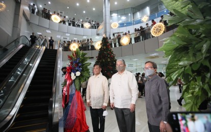 <p><strong>DFA EVENT.</strong> Department of Foreign Affairs Secretary Enrique Manalo (center), Asec. Henry Bensurto Jr. (left), and Usec. Antonio Morales (right) during the ribbon cutting ceremony for the repaired escalators and elevator at DFA-Office of Consular Affairs in Parañaque City. The agency has opened up more passport appointment slots starting this week and up to December 2022. <em>(PNA photo by Avito Dalan)</em></p>