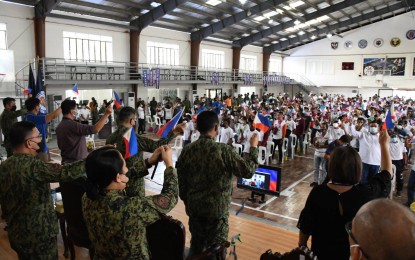 <p><strong>PHILIPPINE FLAG. </strong> Government officials as well as the surrenderers wave the Philippine flag to show their unity and cooperation in denouncing terrorism. At least 204 members of the Alyansang Manggagawang Bukid ng Gitnang Luzon-Nueva Ecija Chapter, Nelson Mesina Command under Kilusang Larangang Guerilla-Tarlac-Zambales, Milisyang Bayan, Kalipuna ng Damayang Mahihirap (Kadamay) and United Luisita Workers Union withdrew their support to the rebel groups in a ceremony held at the PRO-3 regional office in Camp Olivas, Pampanga on Thursday (Oct. 13, 2022). <em>(Photo courtesy of the Police Regional Office-3) </em></p>