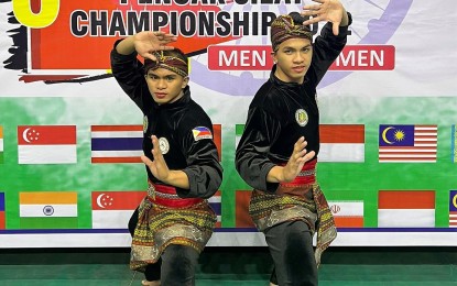 <p><strong>GOLD MEDALISTS.</strong> Alfau Jan Abad and Almohaidib Abad strike a pose during the Seni Ganda Putra (men's double artistic) event in the 6th Asian Pencak Silat Championships that kicked off at the Sheri-Kashmir Indoor Stadium in Srinagar, India on Friday (Oct. 14, 2022). The duo pocketed the gold while the Philippine team also has two silver medals and a bronze in the ongoing six-day tournament. <em>(Contributed photo)</em></p>