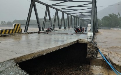 <p><strong>‘NENENG’ IMPACT.</strong> The Tamdagan Bridge in Vintar, Ilocos Norte is impassable to all vehicles on Sunday (Oct. 16, 2022). The swelling of the Bislak River spawned by typhoon Neneng damaged its approach. <em>(Photo courtesy of Vintar LGU)</em></p>