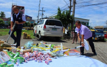 <p><strong>DESTROYED INFERIOR ITEMS.</strong> Rectoniel Reginio (in white polo shirt), the DTI South Cotabato provincial director, leads Monday (Oct. 17, 2022) the disposal of at least PHP100,000 worth of substandard products seized during law enforcement operations last year. The activity was witnessed by the representatives from the Commission on Audit, consumer groups, and the media. (<em>Photo courtesy of PIA South Cotabato)</em></p>
