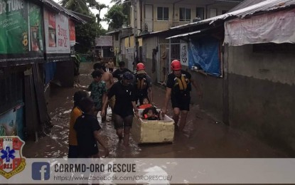 <p><strong>FLOOD.</strong> A rescue team of the Cagayan de Oro city government assist affected families in Barangay Bugo whose houses were submerged in floodwater on Sunday (Oct. 16, 2022). Heavy rains brought about by thunderstorms caused flash floods in Barangays Bugo and Puerto.<em> (Photo courtesy of CDRRMD Oro Rescue)</em></p>