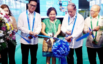 <p><strong>LEAVE NO ONE BEHIND.</strong> Agriculture Undersecretary Domingo F. Panganiban (2nd right), Senator Cynthia Villar (center), and World Food Program Acting Country Director Dipayan Bhattacharyya lead the ribbon cutting during the World Food Day celebration at the DA compound along Visayas Ave. in Quezon City on Monday (Oct. 17, 2022). The government promised safe, nutritious and affordable food for all Filipinos, leaving no one behind. <em> (PNA photo by Ben Briones)</em></p>