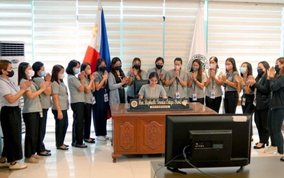 <p><strong>WOMEN EMPOWERMENT.</strong> Female employees of the provincial government of La Union look on as Governor Raphaelle Veronica Ortega-David (seated) signs Executive Order 25 for the Menstruation Day privilege in this undated photo. The EO allows female employees to work from home two days a month when they have their periods. <em>(Courtesy of Gov. Raphaelle Veronica Ortega-David Facebook)</em></p>