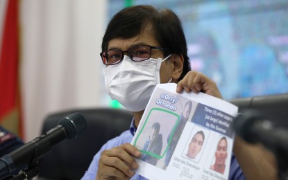 <p><strong>AT-LARGE.</strong> Department of the Interior and Local Government Secretary Benjamin Abalos Jr. shows photos of the other suspects in the killing of broadcaster Percival Mabasa during a press conference in Camp Crame, Quezon City on Tuesday (Oct. 18, 2022). Self-confessed gunman Joel Estorial named his cohorts as brothers Edmon and Israel Dimaculangan and a certain Orly. <em>(PNA photo by Joey O. Razon)</em></p>