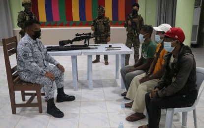 <p><strong>SURRENDER.</strong> Three followers of the late Isnilon Hapilon, the appointed emir of all Islamic State Forces in the Philippines, surrender to military authorities Monday (October 17, 2022) in Basilan province. The three (seated, right) were presented on the same day to Rear Admiral Toribio Adaci Jr., commander of the Naval Forces Western Mindanao (left) at the Naval Station Romulo Espaldon in Zamboanga City. <em>(Photo courtesy of Naval Forces Western Mindanao)</em>  </p>