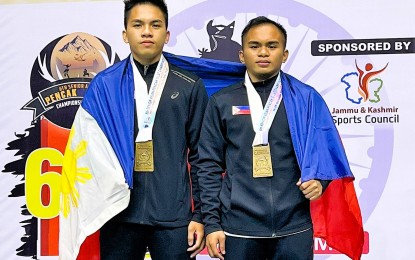 <p><strong>PERFECT COMBINATION.</strong> Brothers Almohaidib and Alfau Jan Abad pose with their gold medals in Seni Ganda Putra (men's double artistic) event during the awarding ceremony of the 6th Asian Pencak Silat Championships held at the Sheri-Kashmir Indoor Stadium in Srinagar, India on Oct. 14, 2022. It was the siblings' second gold medal in an international competition. <em>(Contributed photo)</em></p>