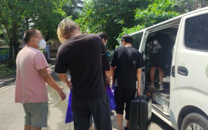 <p><strong>BACK TO CHINA</strong>. Six Chinese nationals working in Philippine Overseas Gaming Operations (POGO) board a van that will take them to the airport as part of their deportation on Wednesday (Oct. 19, 2022). The initial target for deportation this month is set at 3,000 foreign nationals. <em>(Photo courtesy of Karen VIllanda/PTV)</em></p>