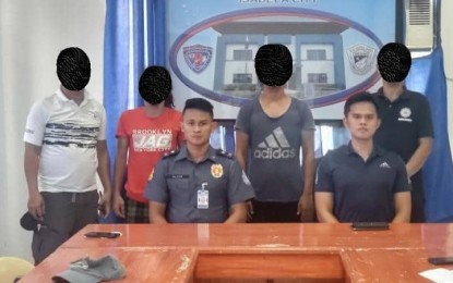 <p><strong>SURRENDER.</strong> Two members of the Abu Sayyaf Group (standing 2nd and 3rd from left) surrender Tuesday (Oct. 18, 2022) to the police in Isabela City, Basilan. The surrenderers said they went into hiding after their leader was killed in a clash with government troops in 2020 in R.T. Lim town, Zamboanga Sibugay. <em>(Photo courtesy of CIDG - Peninsula)</em></p>