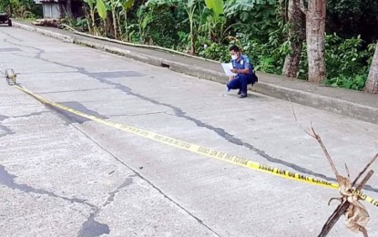 <p><strong>CRIME SCENE</strong>. A police investigator processes the crime scene where a village councilman was shot dead on Friday noon (Oct. 21, 2022) in Bayawan City, Negros Oriental. This is the second incident this week where a barangay official was killed in the province.<em> (Photo courtesy of the Negros Oriental Provincial Police Office)</em></p>