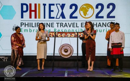 <p><strong>TRAVEL EXCHANGE</strong>. Tourism Secretary Christina Frasco (2nd from left) and Tourism Promotions Board Chief Operating Officer Margarita Nograles (right) grace the opening of the Philippine Travel Exchange 2022 at the Manila Marriott Hotel on Oct. 19, 2022. This year's event has generated a record-breaking PHP172.6 million in bookings, the Department of Tourism reported on Saturday (Oct. 22, 2022). <em>(Photo from DOT)</em></p>