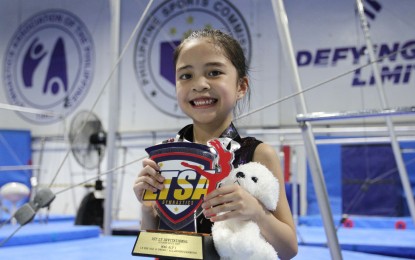 <p><strong>CHAMPION</strong>: Sabrina Richelle Lagman poses with her medals and trophy during the awarding ceremony of the Learn and Train Sports Academy Invitational at the MVP Sports Foundation Gymnastics Center in Intramuros, Manila on Sunday (Oct. 23, 2022). She won the all-around event in the 6-years-old and under category. <em>(PNA photo by Joseph Razon)</em></p>