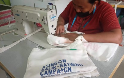 <p><strong>LIVELIHOOD</strong>.  A person with disability in Asingan town in Pangasinan sews an eco bag. Eco bag and candle making are among the sources of income of some of persons with disabilities in the town. <em>(Photo courtesy of Mel Aguilar/ PIO Asingan)</em></p>