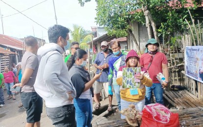 <p><strong>SEIZED</strong>. Agriculture and veterinary personnel document the confiscation of five kilos of raw pork that came from Capiz at a wake in Barangay Tuburan, E.B. Magalona, Negros Occidental on Tuesday (Oct. 25, 2022). Starting Oct. 14, Negros Occidental prohibited the entry of all pigs, pork, pork products, and other related items from the neighboring provinces of Iloilo, Antique, Capiz, Aklan, and Guimaras, following a reported incidence of African swine fever in Oton, Iloilo. <em>(Photo courtesy of E.B. Magalona, Negros Occidental PIO)</em></p>