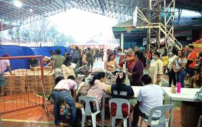 <p><strong>FLOOD VICTIMS.</strong> Evacuees queue up to receive relief goods at the gymnasium in Guihulngan City, Negros Oriental on Wednesday (Oct. 26, 2022). More than 180 families, consisting of 1,100 individuals, were displaced by massive flooding in the city's central district after a river in Sitio Bateria overflowed due to non-stop rains brought about by Paeng.<em> (Photo courtesy of the 62IB, Philippine Army)</em></p>