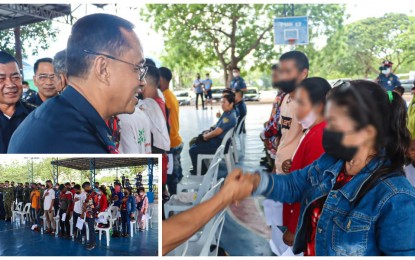<p><strong>WELCOME BACK.</strong> Brig. Gen. Jimili Macaraeg, Soccsksargen Region police director, welcomes the 15 communist New People’s Army rebels who surrendered during ceremonies at the regional police headquarters in General Santos City on Wednesday (Oct. 26, 2022). The rebels (inset) that included women fighters were operating at the borders of Sarangani, South Cotabato, and Sultan Kudarat. <em>(Photo courtesy of PRO-12)</em></p>