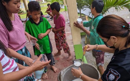<p class="p1"><span class="s1"><strong>ARROZ CALDO.</strong> A staffer of the City Social Welfare and Development Office (right) serves arroz caldo to children of families displaced by Tropical Storm Paeng Friday (October 28, 2022) in Barangay Ayala, Zamboanga City. Torrential rains brought about by TS Paeng inundated 21 of the 98 barangays in Zamboanga City that saw the displacement of more than 1,000 families. <em>(Photo courtesy of Zamboanga CIO)</em></span></p>