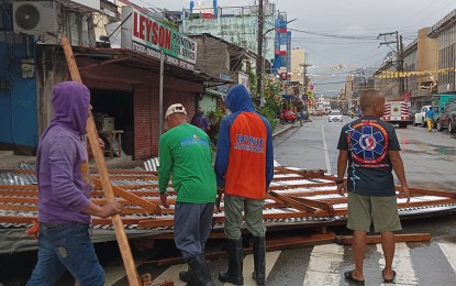 <p><strong>AFTERMATH.</strong> Surigao City rescue personnel conduct clearing operations of debris left by Severe Tropical Storm Paeng on Saturday (Oct. 29, 2022). A total of 170 families in Surigao City and 55 in Dinagat Islands sought refuge in evacuation centers the night before. <em>(Courtesy of Surigao City-PIO)</em></p>