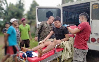 <p><strong>HUMANITARIAN.</strong> Lt. Col. Christian Uy (center), commander of the Army's 58th Infantry Battalion of the 4th Infantry Division, checks on a wounded New People’s Army rebel in Misamis Oriental on Saturday (Oct. 29, 2022).  The rebel was left by his fleeing comrades following an encounter with the military. <em>(Courtesy of 58IB-4ID)</em></p>