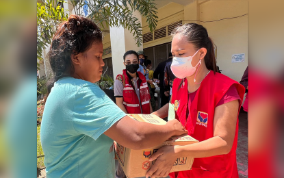 <p><strong>FOOD PACKS.</strong> A housewife receives Wednesday (Nov. 2, 20220) a family food pack (FFP) from a staff of the Department of Social Welfare and Development (DSWD) in one of the evacuation centers in Zamboanga City. The DSWD has so far distributed 9,115 FFPs to families displaced by Severe Tropical Storm Paeng in Zamboanga City.<em> (Photo courtesy of DSWD-Zamboanga Peninsula)</em></p>