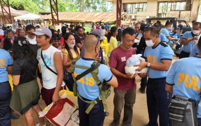 <p><strong>'BARANGAYANIHAN'.</strong> Police personnel distribute food packs during a recent "Barangayanihan" activity in Barangay Candabong, Manjuyod town in Negros Oriental. A similar activity is set in Barangay Dahile, Mabinay town on Friday (Nov. 4, 2022) through the Task Force to End Local Communist Armed Conflict. <em>(Photo courtesy of the Negros Oriental Provincial Police Office)</em></p>