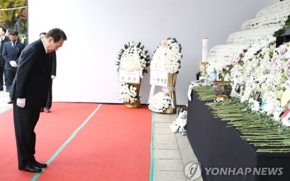 <p><strong>MOURNING.</strong> President Yoon Suk-yeol bows his head in silent tribute to the victims of the Halloween crowd crush on Thursday (Nov. 3, 2022) at a mourning altar in front of City Hall in Seoul. This visit was his third and fourth overall, including a visit to a mourning altar near the site of the tragedy. <em>(Yonhap)</em></p>