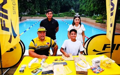 <p><strong>SWIMMING TILT. </strong>FINIS Philippines Managing Director Vince Garcia (seated left) with new Brand Ambassador Jamesray Ajido, a national junior swimming record-holder in the 50-meter and 100-m butterfly; 200-m and 400-m individual medley; and 100-m and 200-m backstroke. More than 200 swimmers from 25 teams and clubs are vying in the Visayas leg of the FINIS Philippines National Long Course Series on November 5 and 6, 2022 at the Iloilo Sports Complex Swimming pool in La Paz, Iloilo City. <em>(Contributed photo)</em></p>