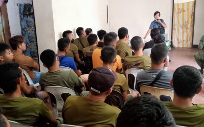 <p><strong>AWARENESS LECTURE</strong>. The police in Guihulngan City, Negros Oriental conduct an awareness lecture for militiamen and 62IB personnel in this undated photo in Camp McKinley. The Special Citizens Armed Forces Geographical Unit (CAFGU) Active Auxiliary (SCAA) members are utilized as force multipliers to help law enforcers in peace and security efforts, territorial defense, and disaster response. <em>(Photo from Guihulngan Police Station's Facebook page)</em></p>