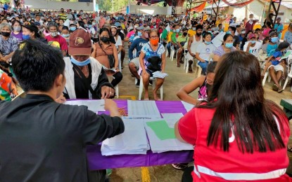 <p><strong>PAYOUT</strong>. Personnel of the Department of Social Welfare and Development 6 (Western Visayas) distribute cash aid to residents of Himamaylan City, Negros Occidental affected by the armed conflict in October during the payout in Barangay Carabalan on Nov. 4, 2022. A total of PHP10.01 million were released to more than 3,000 displaced families under the Armed Conflict Financial Assistance program. <em>(Photo courtesy of Himamaylan City Social Welfare and Development Office)</em></p>