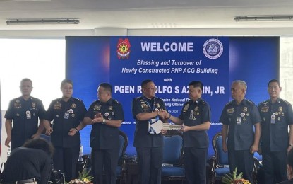 <p><strong>BOOSTING CYBERCRIME RESPONSE.</strong> Philippine National Police chief, Gen. Rodolfo Azurin Jr. (4th from left), turns over the ceremonial key of the new Anti-Cybercrime Group (ACG) building to ACG chief, Brig. Gen. Joel Doria (3rd from right), during the blessing and turnover ceremony in Camp Crame, Quezon City on Wednesday (Nov. 9, 2022). Azurin said the PNP is in need of 1,500 police personnel with information technology (IT) skills to beef up its anti-cybercrime drive.<em> (Photo courtesy of PNP)</em></p>