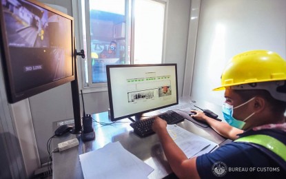 <p><strong>CURBING CONTRABAND.</strong> A Customs officer checks goods loaded in a cargo truck through the use of an X-ray scanner at one of the country's ports in this undated photo. The BOC on Thursday (Nov. 10, 2022) said it has provided additional X-ray machines to different ports to strengthen its measures to prevent the entry of smuggled and illicit goods. <em>(Photo courtesy of BOC)</em></p>