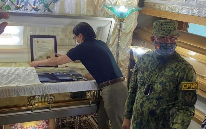 <p><strong>LAST RESPECTS</strong>. Interior Secretary Benhur Abalos (left) and PNP Director, Gen. Rodolfo Azurin Jr., visit the remains of Lt. Reynaldo Samson, police chief of Ampatuan, Maguindanao del Sur, who was killed in an ambush on Aug. 30, 2022. Police on Thursday (Nov. 10, 2022) filed charges against 10 armed suspects in connection with the ambush. <em>(Photo courtesy of DXMS Cotabato)</em></p>